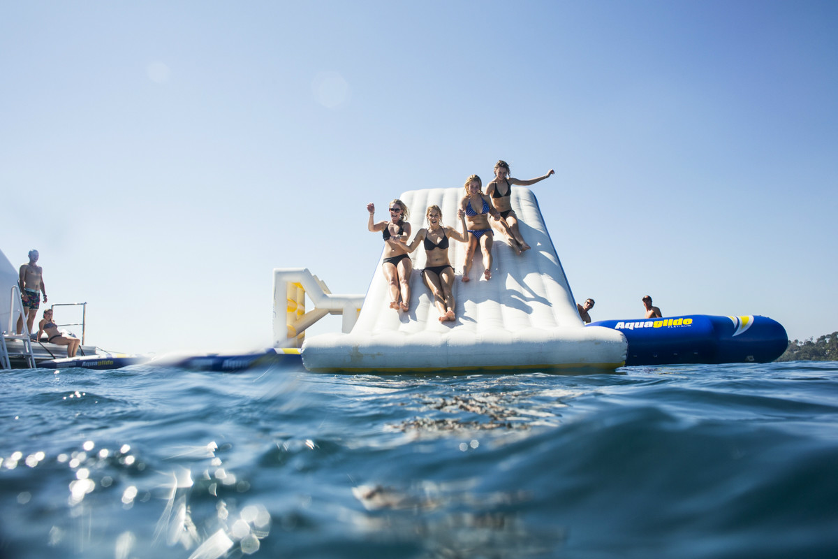 Guests enjoying water toys and swimming during a Corsica yacht charter