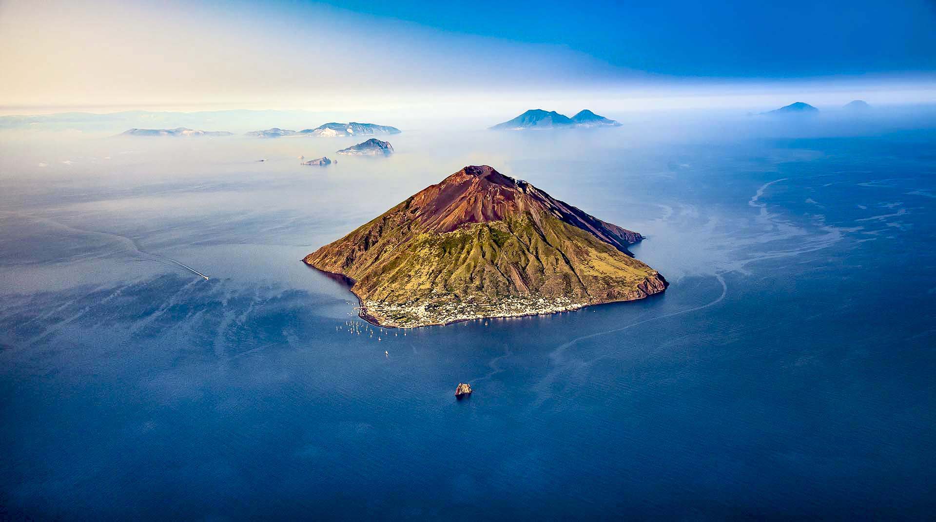 Yacht anchored off Stromboli’s volcanic coast at sunset, Aeolian Islands