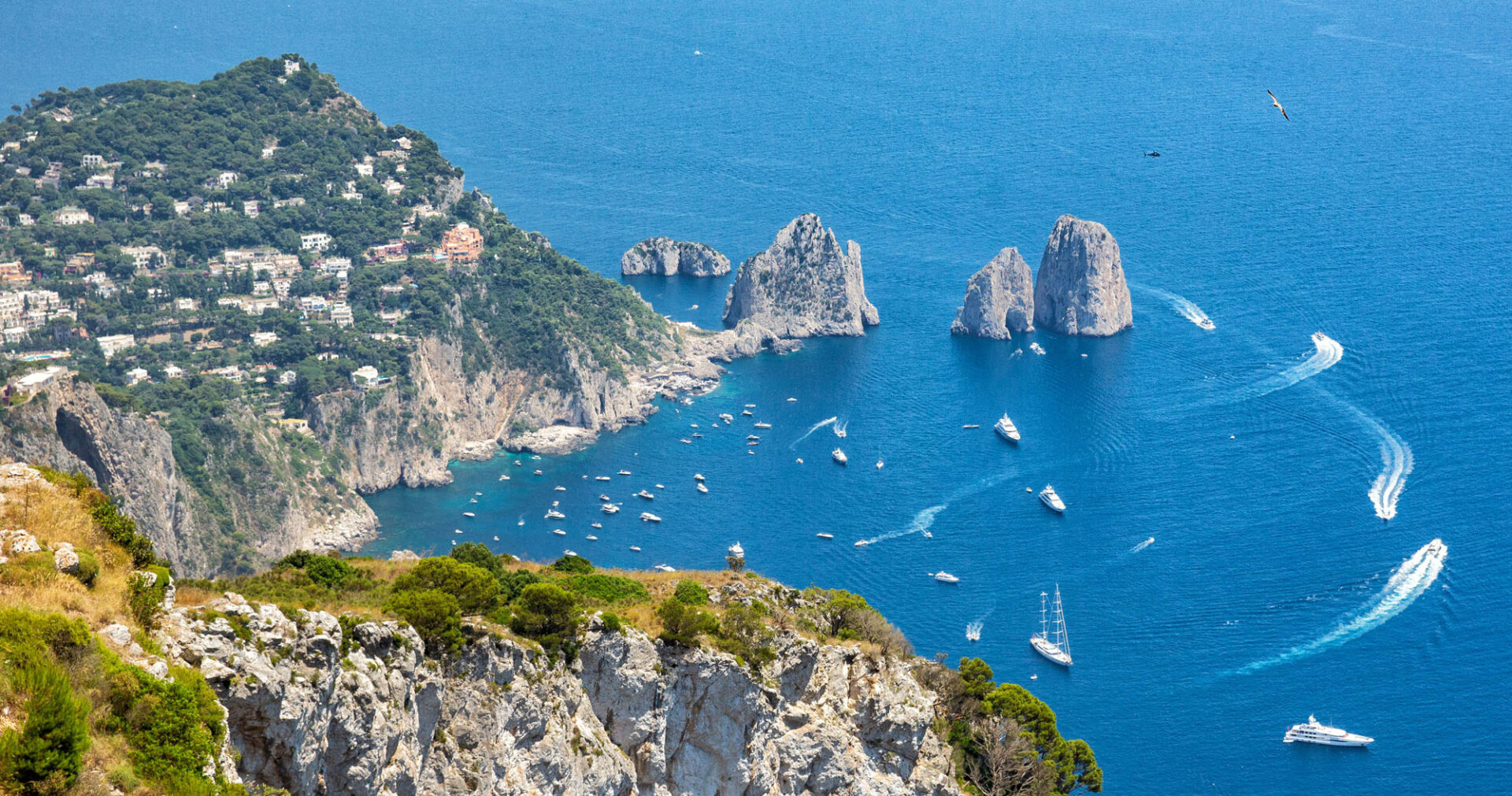 Capri Yacht Charter with panoramic views of Faraglioni and luxury onboard living