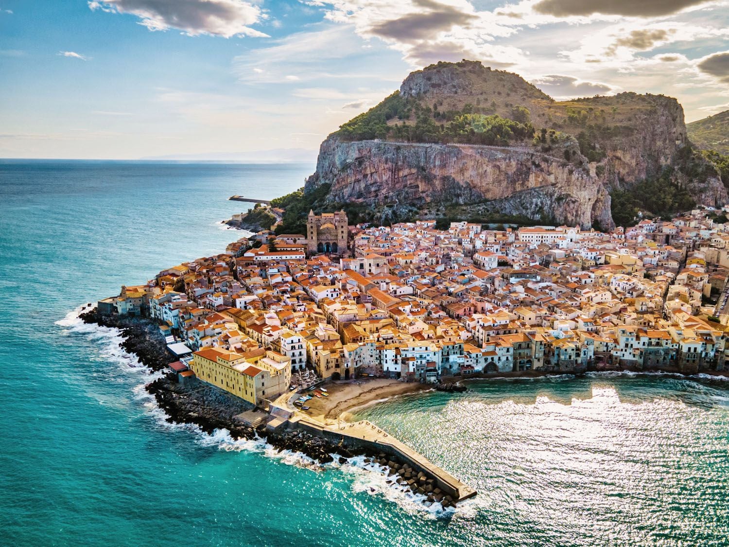 Luxury yacht anchored near Cefalù’s historic coastal town, Sicily